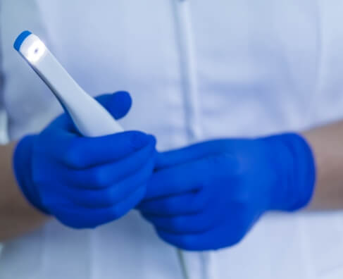 Gloved hand holding laboratory test tube in clinical healthcare setting