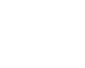 Dental professional in white coat examining patient's teeth in modern clinic setting.