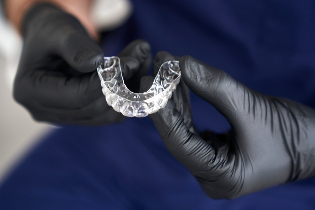 Dentist holding an aligner